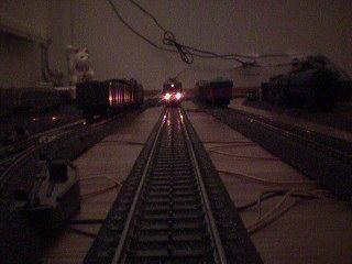 Looking down the track at night, two lights stare back at us!